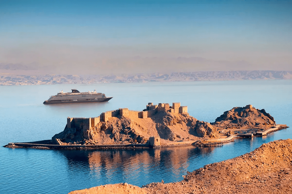 cruiseship cruising past an old fort