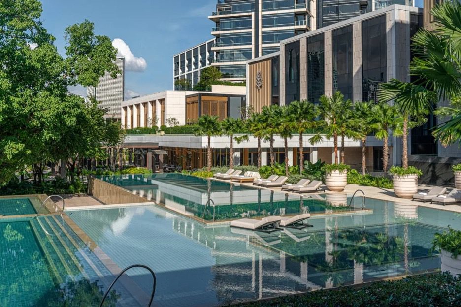 a sleek multi-tiered outdoor pool in the courtyard of a modern building